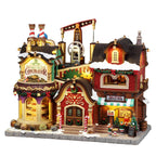 LEMAX 65521 The Holly Jolly Chocolatier & Mrs Claus Coffee Shop - Lighted Christmas Village Building with Sound (2026)